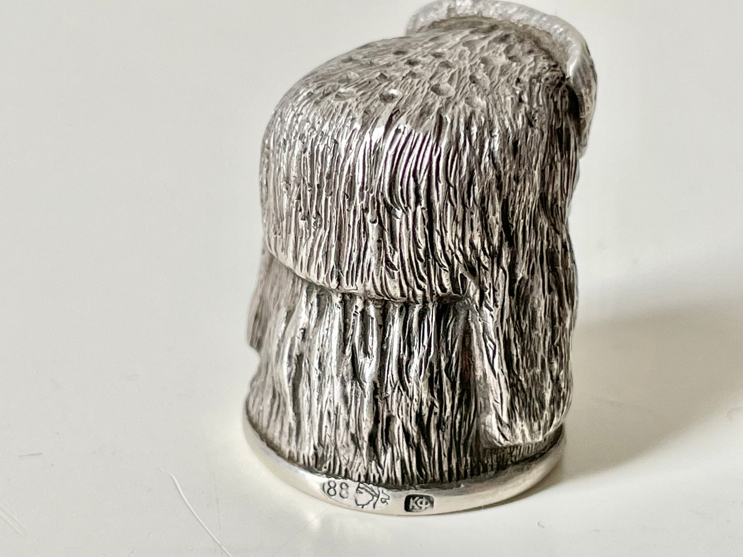 Ruby-eyed silver peasant head sewing thimble wearing Faberge mark