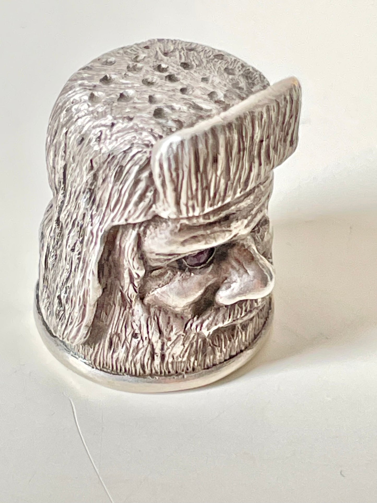 Ruby-eyed silver peasant head sewing thimble wearing Faberge mark