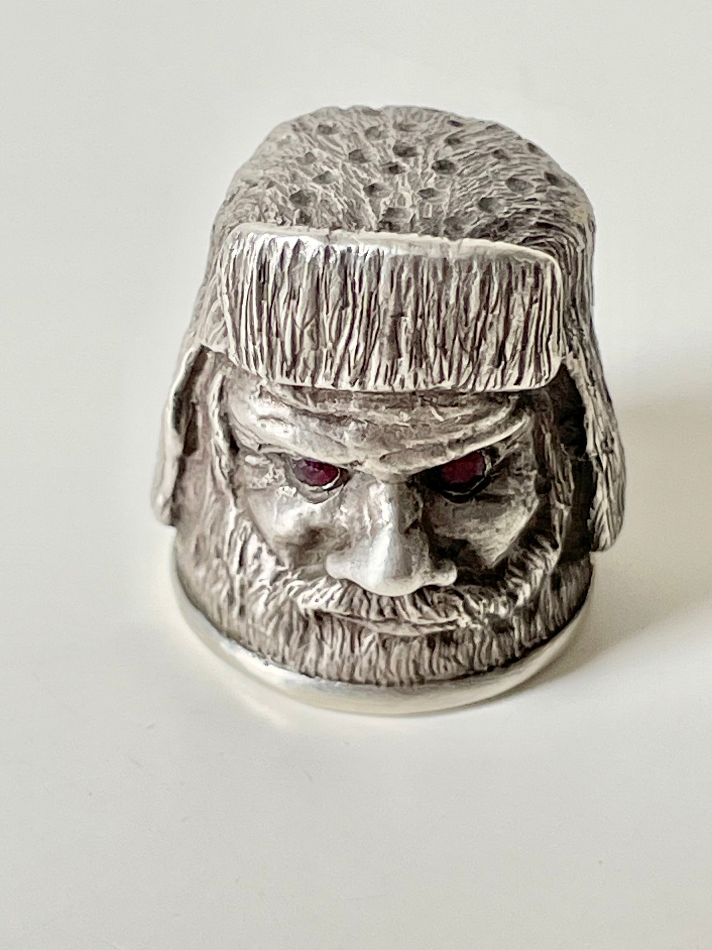 Ruby-eyed silver peasant head sewing thimble wearing Faberge mark