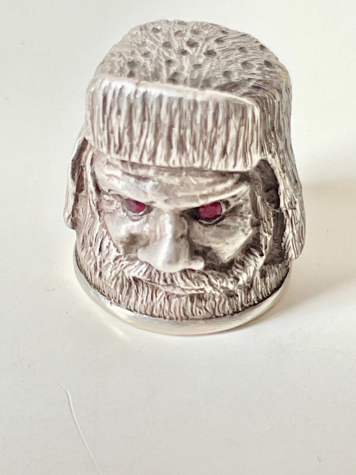 Ruby-eyed silver peasant head sewing thimble wearing Faberge mark