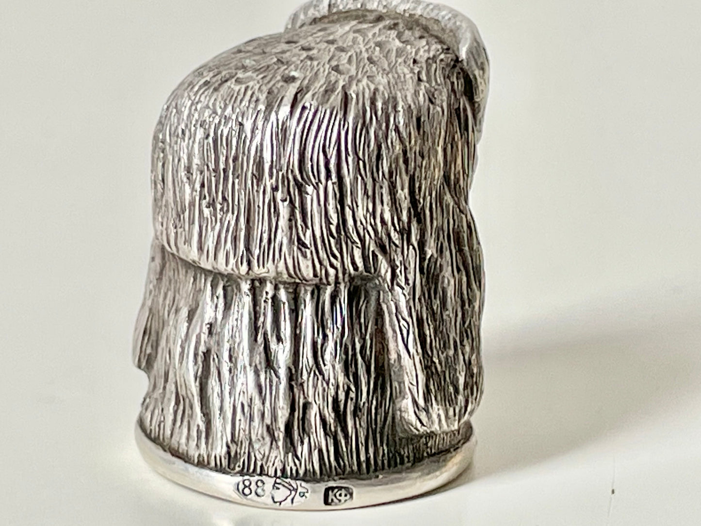 Ruby-eyed silver peasant head sewing thimble wearing Faberge mark