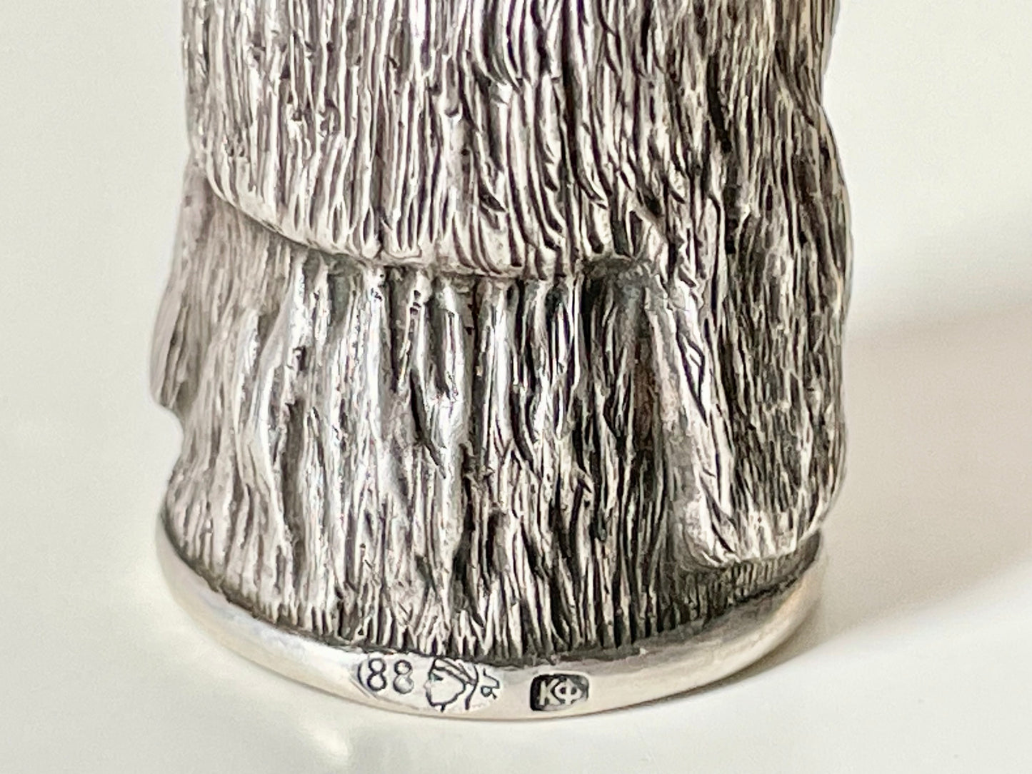 Ruby-eyed silver peasant head sewing thimble wearing Faberge mark