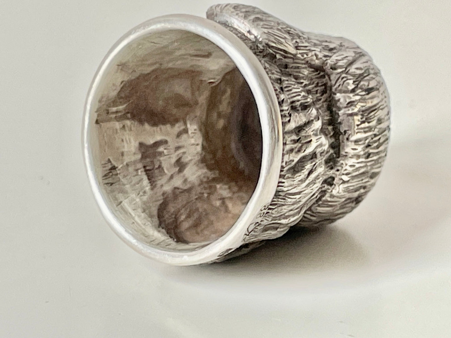 Ruby-eyed silver peasant head sewing thimble wearing Faberge mark