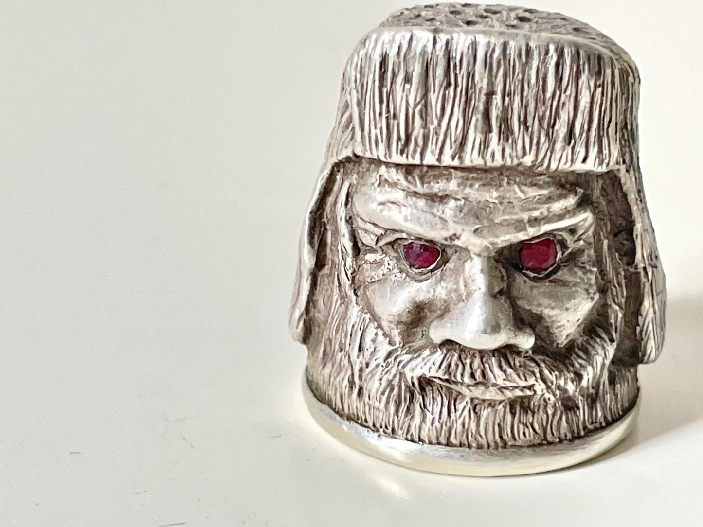 Ruby-eyed silver peasant head sewing thimble wearing Faberge mark