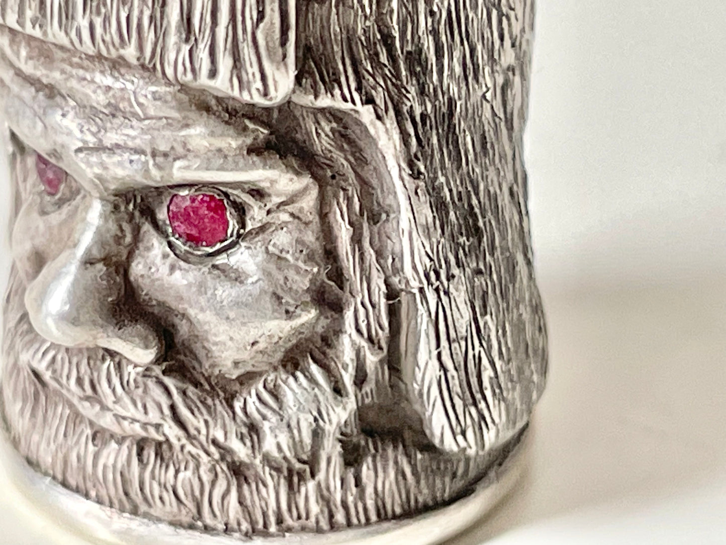 Ruby-eyed silver peasant head sewing thimble wearing Faberge mark
