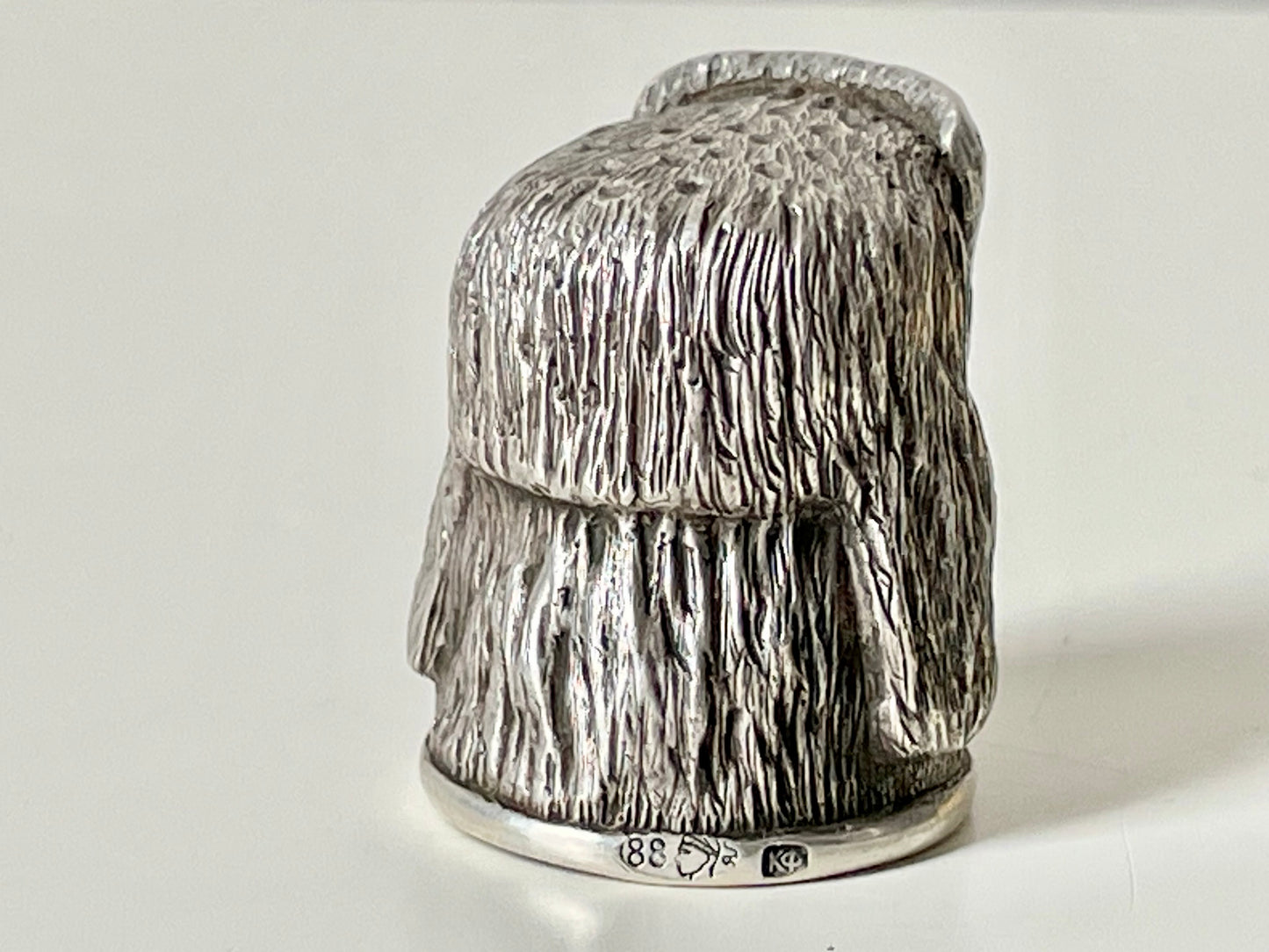 Ruby-eyed silver peasant head sewing thimble wearing Faberge mark