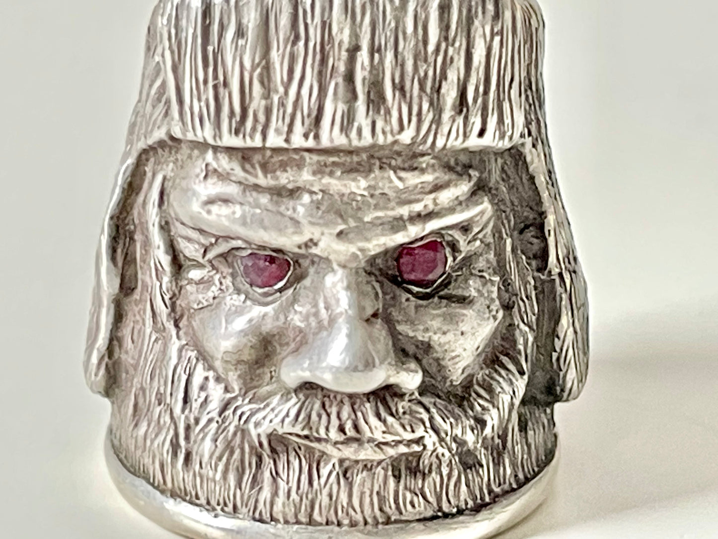 Ruby-eyed silver peasant head sewing thimble wearing Faberge mark