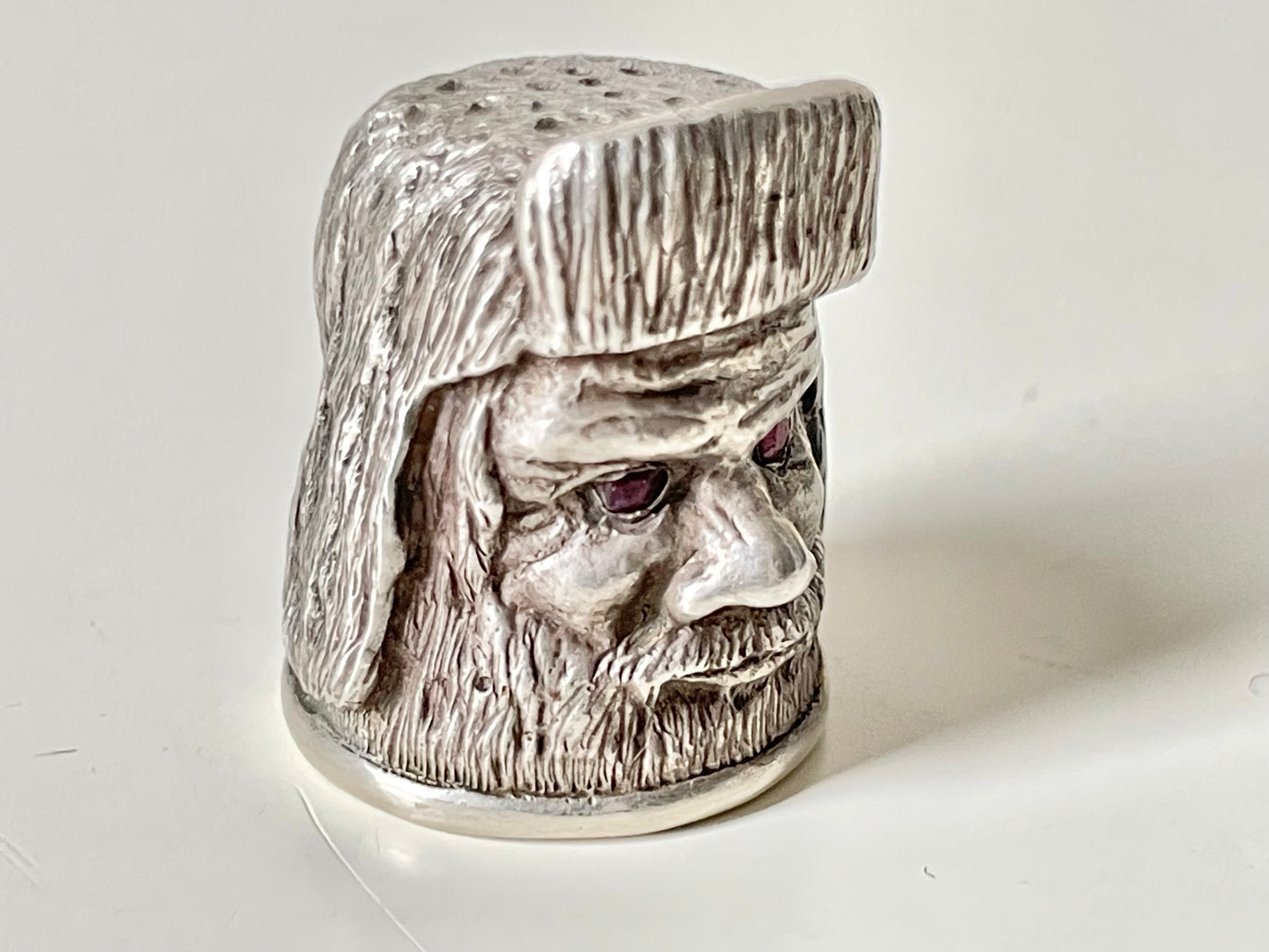 Ruby-eyed silver peasant head sewing thimble wearing Faberge mark