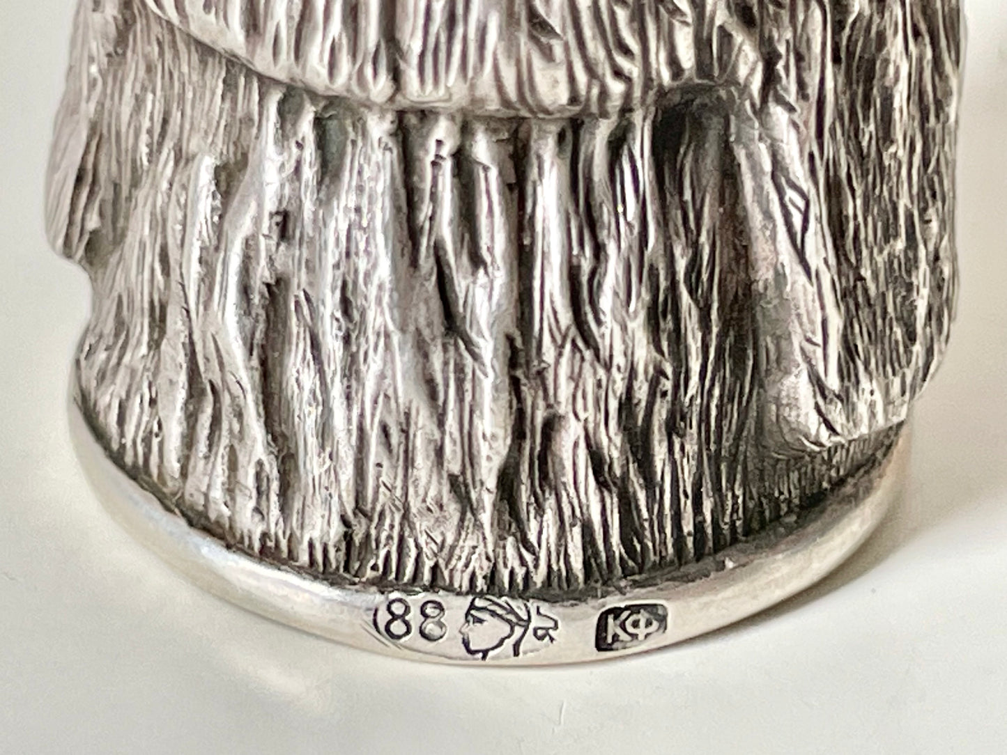 Ruby-eyed silver peasant head sewing thimble wearing Faberge mark