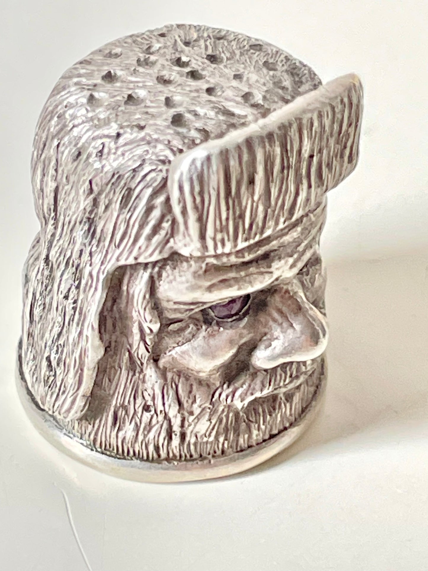 Ruby-eyed silver peasant head sewing thimble wearing Faberge mark