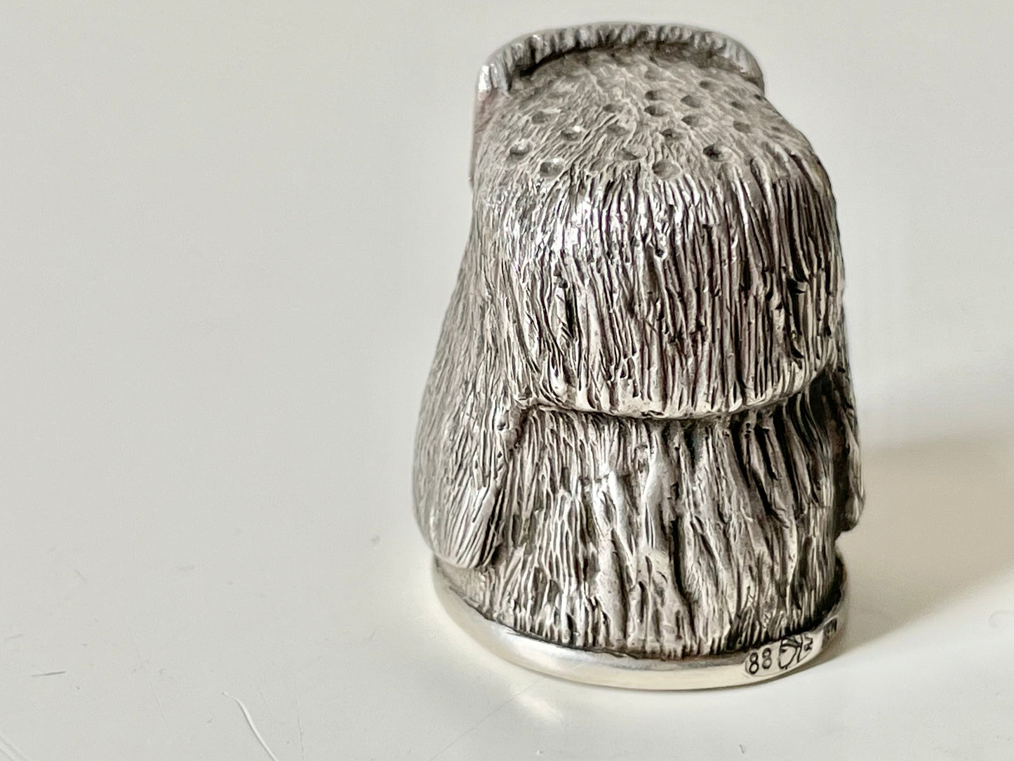 Ruby-eyed silver peasant head sewing thimble wearing Faberge mark