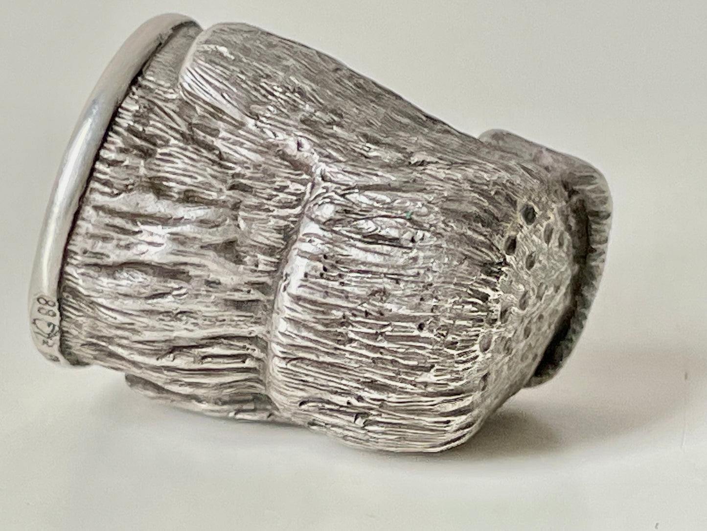 Ruby-eyed silver peasant head sewing thimble wearing Faberge mark