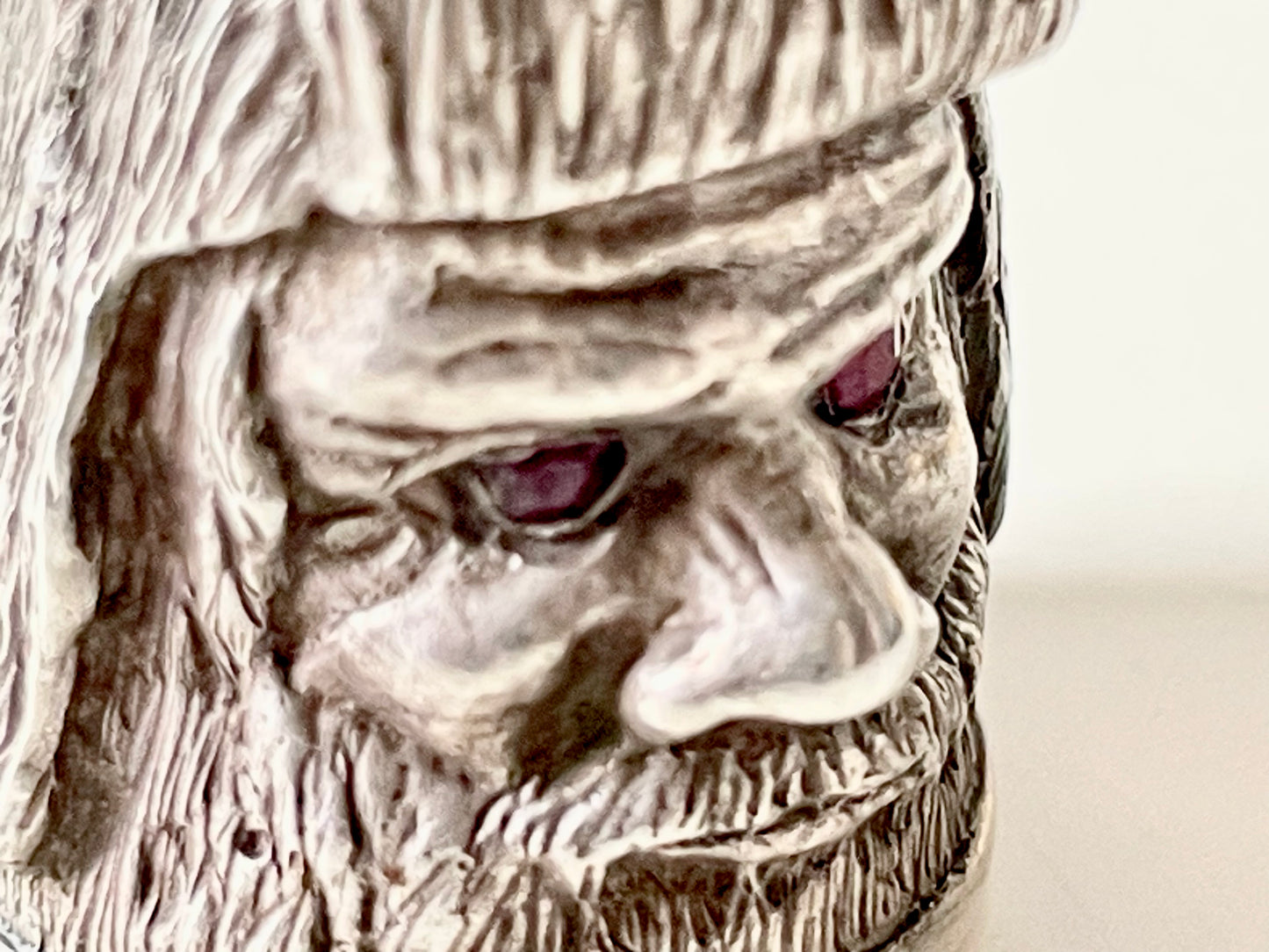 Ruby-eyed silver peasant head sewing thimble wearing Faberge mark