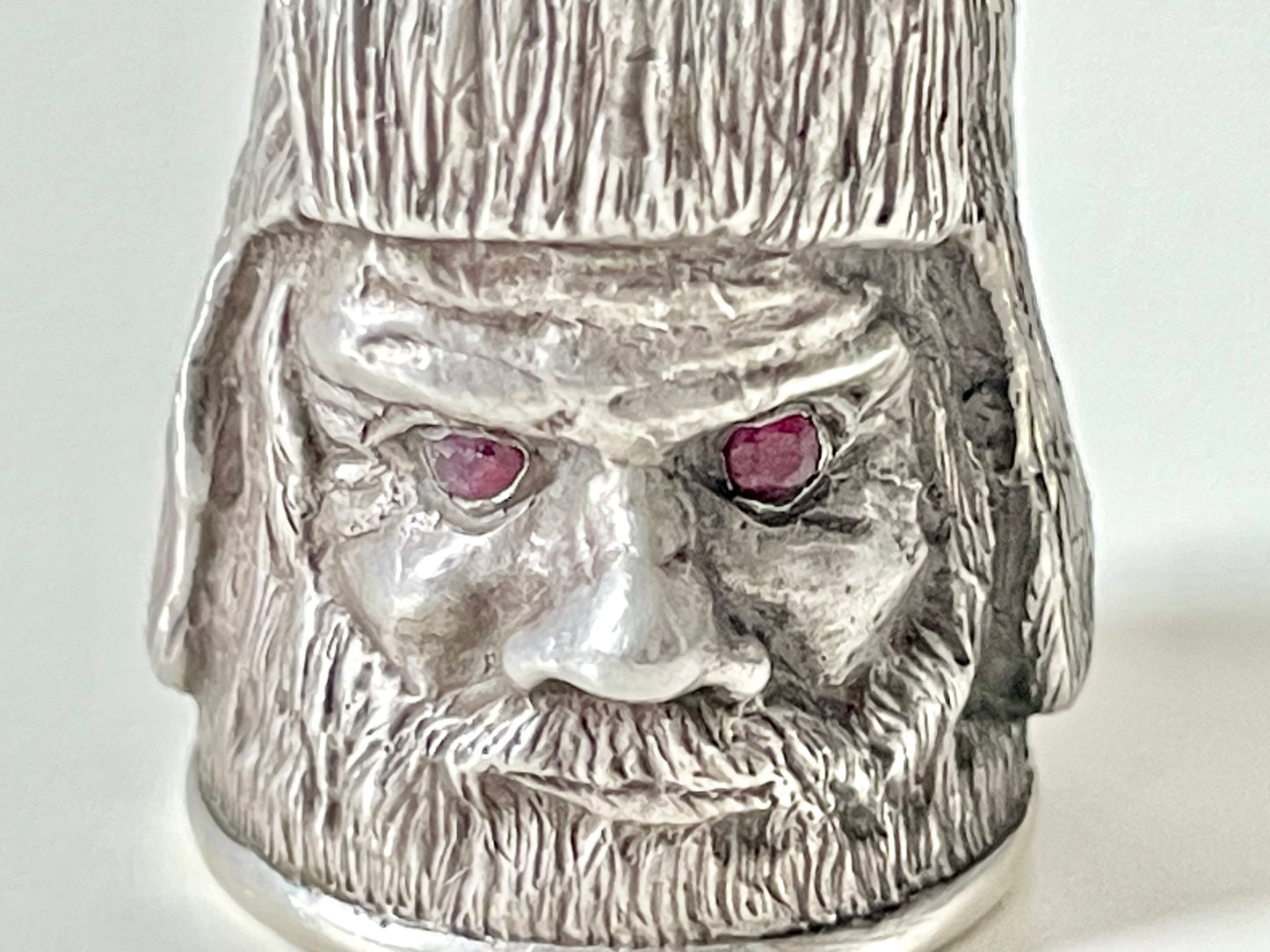 Ruby-eyed silver peasant head sewing thimble wearing Faberge mark